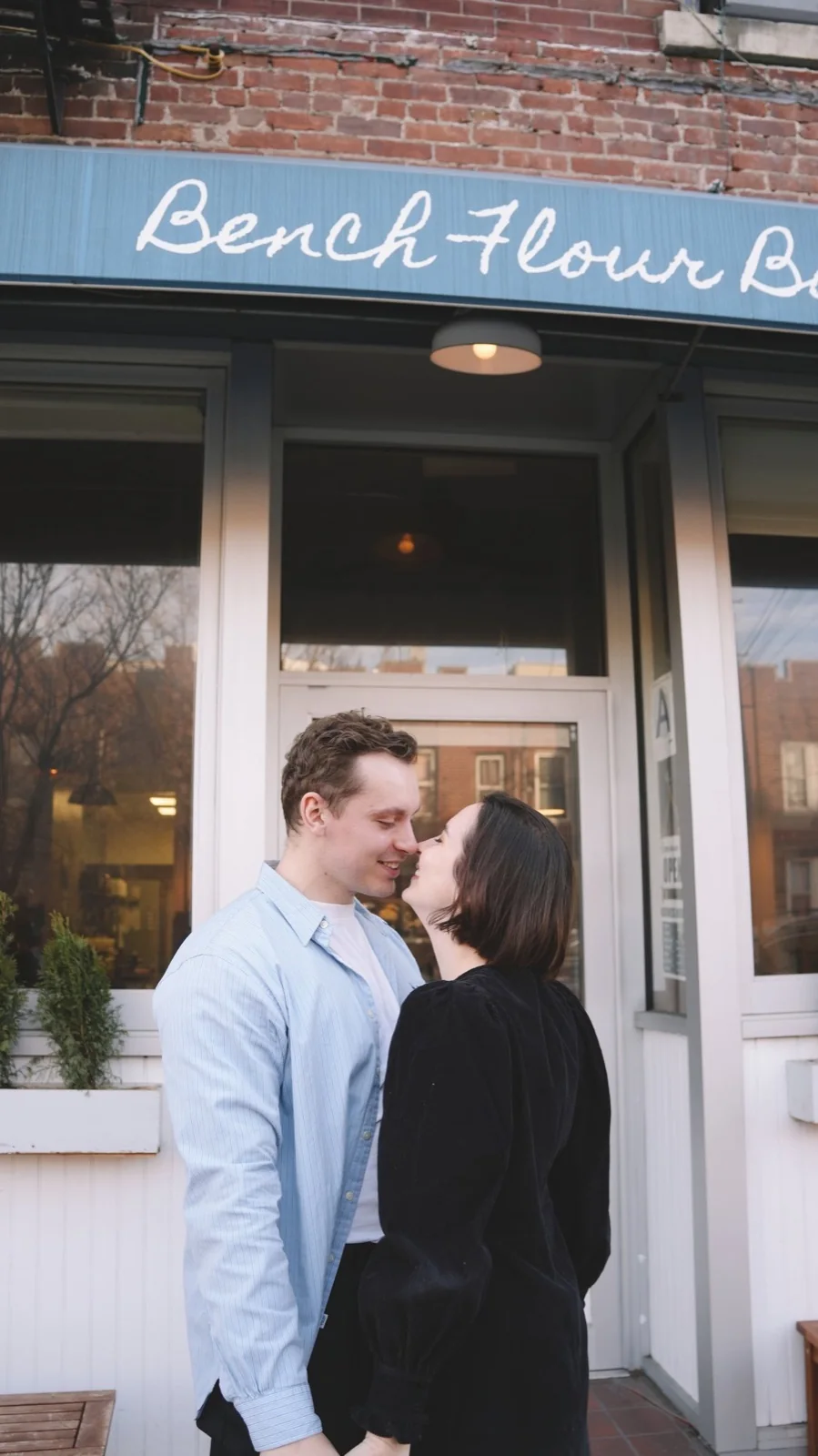 A couple leaning close together in a New York doorway
