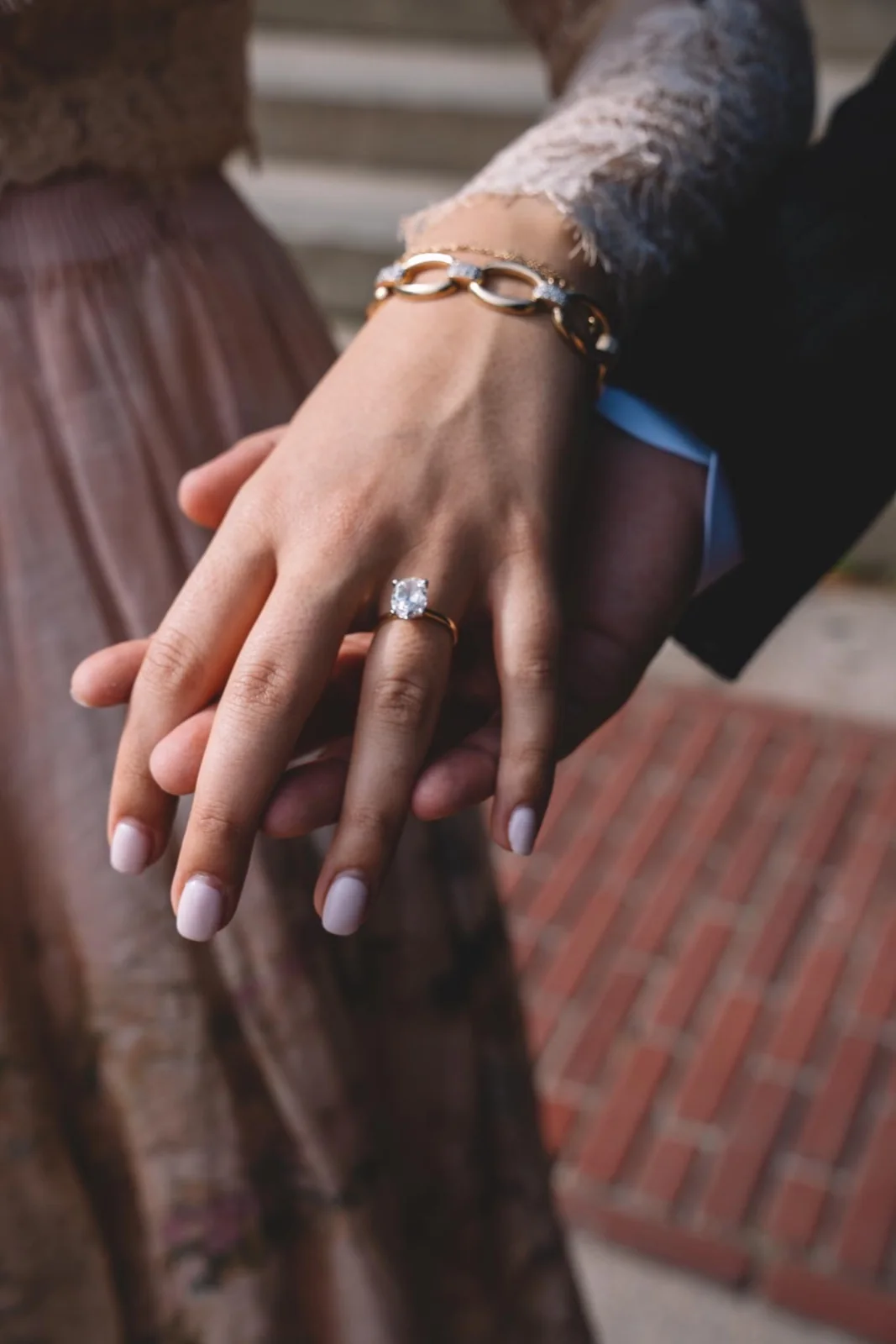 Close-up of a ring on a hand resting against a partner's suit