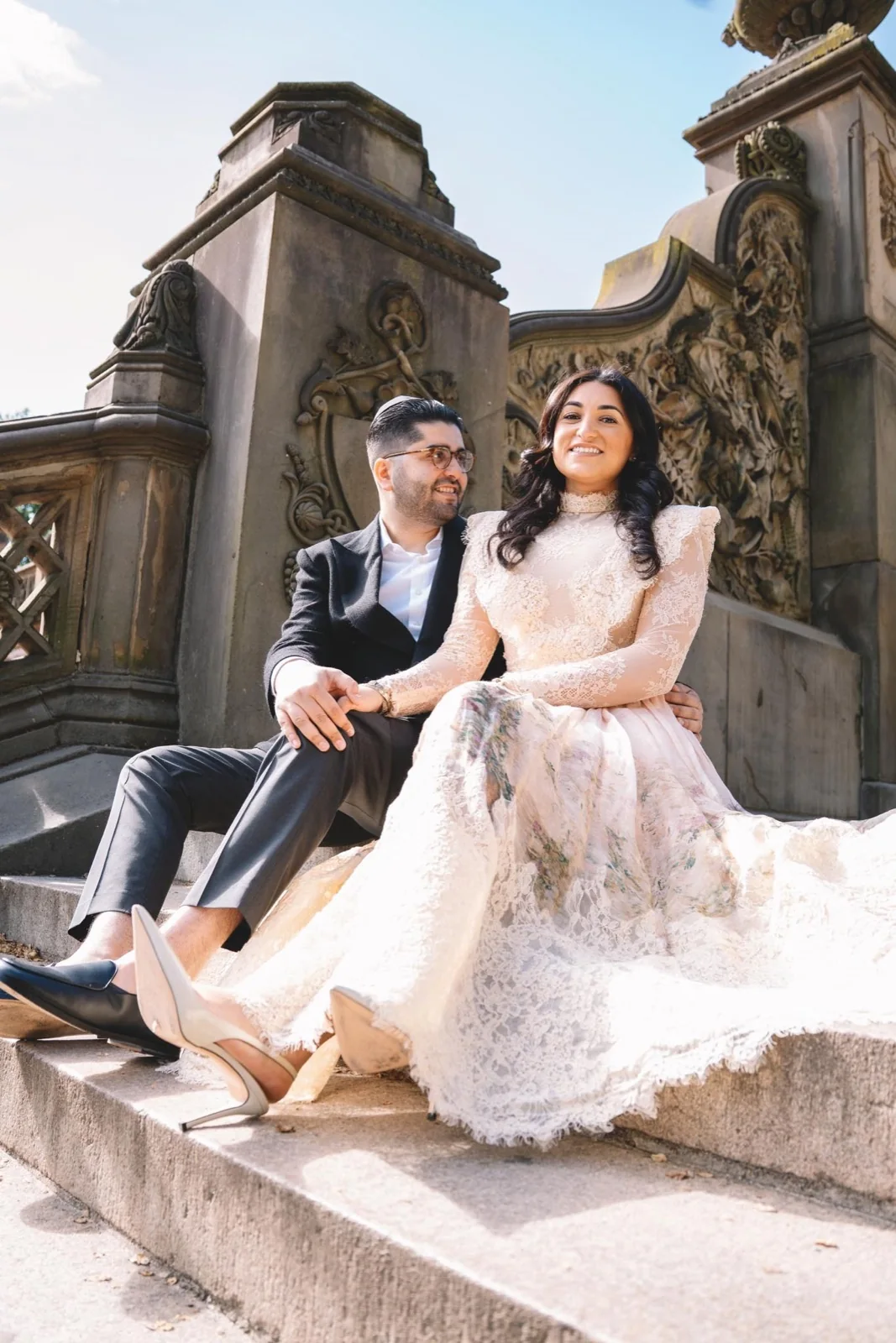 A couple sharing a smile on the steps of Bethesda Terrace