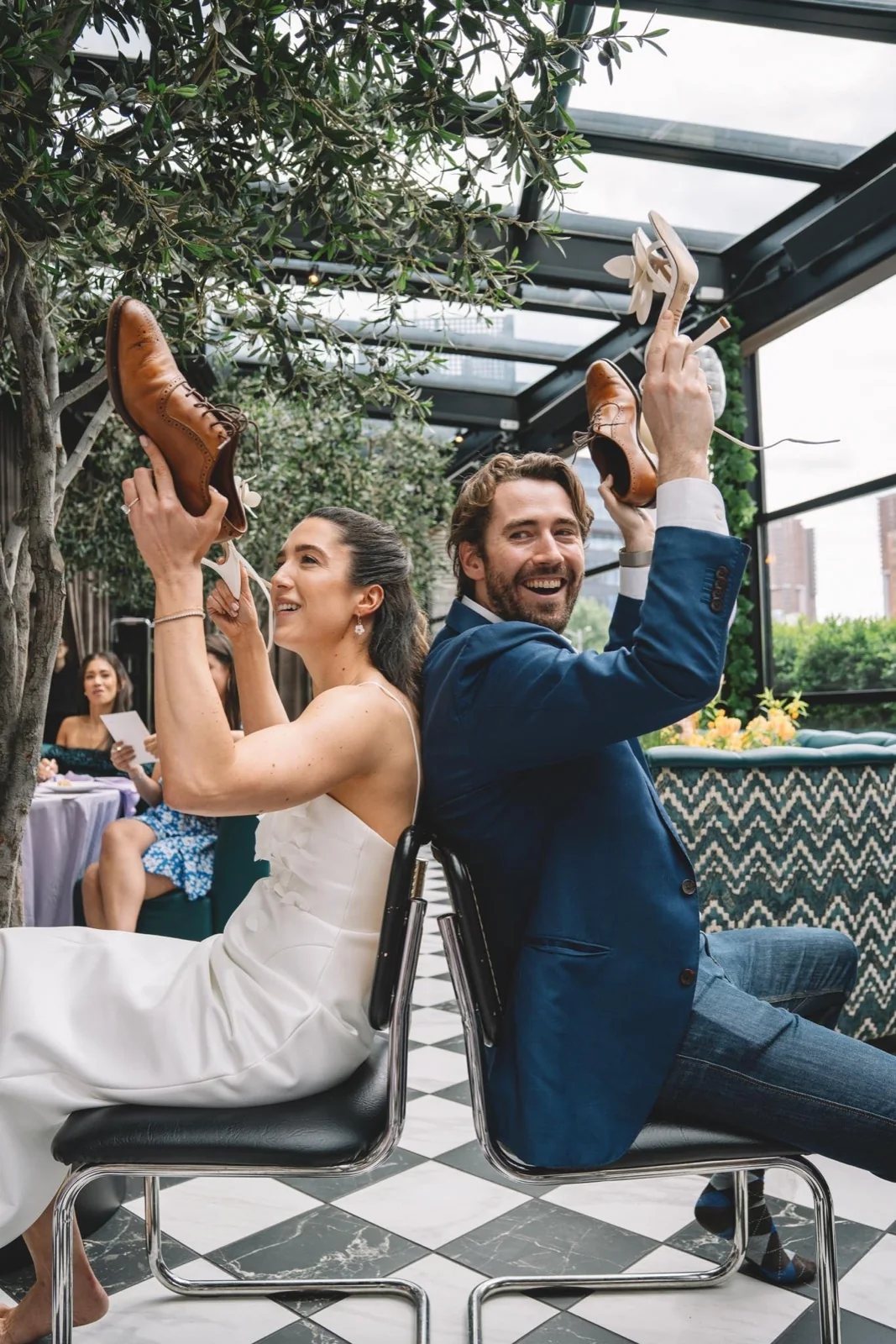 Newlyweds lifting their hands and celebrating at their reception